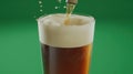 Beer pouring pint glass, green background, studio shot, advertisement Royalty Free Stock Photo