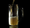 Beer pouring into a tall mug isolated Royalty Free Stock Photo