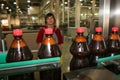 Beer production. On the conveyor, two liter bottles of drinks. Brown colo