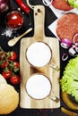 Beer and Raw Ground beef meat Burger steak cutlets with seasoning and vegetables Royalty Free Stock Photo