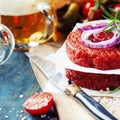 Beer and Raw Ground beef meat Burger steak cutlets with seasonin Royalty Free Stock Photo