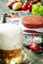 Beer and Raw Ground beef meat Burger steak cutlets with seasonin Royalty Free Stock Photo