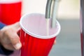 Beer in red cup. Red Plastic Drinking Cups. Plastic red solo drinking cups for beer pong or drinking game. Royalty Free Stock Photo