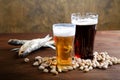 Beer with salty nutlets and fish Royalty Free Stock Photo