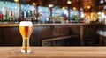 beer served in a glass on a bar with a background of a bar in high resolution. liquor concept