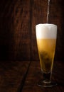 Beer served in a glass with rustic wood background Royalty Free Stock Photo