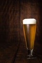 Beer served in a glass with rustic wood background Royalty Free Stock Photo