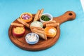 Beer set with onion rings, bread toasts and sauces according to the Mediterranean recipe Royalty Free Stock Photo