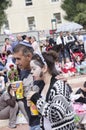 Beer-Sheva, ISRAEL - March 5, 2015: Father and daughter in costume drink juice in the crowd on the street - Purim