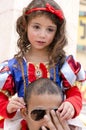 Beer-Sheva, ISRAEL - March 5, 2015: Girl dressed as Snow White Disney cartoon with a red bow on the shoulders of his father-Purim
