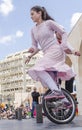 Beer-Sheva, ISRAEL - March 5, 2015:The girl in a pink dress on a bicycle with one wheel -Purim
