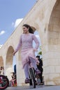Beer-Sheva, ISRAEL - March 5, 2015: The girl in a pink dress on a bicycle with one wheel - Purim