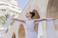 Beer-Sheva, ISRAEL - March 5, 2015: Gymnast girl in white dress on the street scene Purim