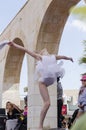 Beer-Sheva, ISRAEL - March 5, 2015:Gymnast girl in white dress on the street scene -Purim