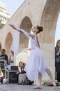 Beer-Sheva, ISRAEL - March 5, 2015: Gymnast girl in white dress on the street scene - Purim