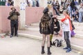Beer-Sheva, ISRAEL - March 5, 2015: The man with the video camera shoots people in carnival costumes. Girl in black with long hair