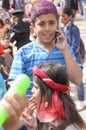 Beer-Sheva, ISRAEL - March 5, 2015: Teenager boy with purple hair dyed in a blue striped shirt with mobile phone and girl Royalty Free Stock Photo