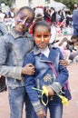 Beer-Sheva, ISRAEL - March 5, 2015: Two dark-skinned teen girl in denim dress with butterflies makeup on their faces - Purim Royalty Free Stock Photo