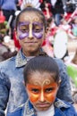 Beer-Sheva, ISRAEL - March 5, 2015: Two dark-skinned teen girl in denim dress with butterflies makeup on their faces - Purim Royalty Free Stock Photo