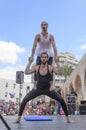 Beer-Sheva, ISRAEL - March 5, 2015: Two men, clowns, gymnasts, one of them in a tutu - with exercises on the open stage - Purim Royalty Free Stock Photo