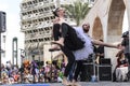 Beer-Sheva, ISRAEL - March 5, 2015: Two men, clowns, gymnasts, one of them in a tutu on the open stage - Purim Royalty Free Stock Photo