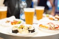 Beer and small buffet bites in plates on table food and drink concept Royalty Free Stock Photo