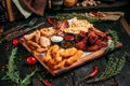 Beer snack with chicken breast pieces, wings, cheese and fish with sauces