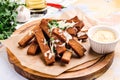 Beer snack fried croutons with cheese sauce on wooden board. Rye bread croutons with garlic, oil and salt. Drinks and