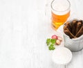Beer snack set. Pint of pilsener in mug and rye bread croutons with garlic cream cheese sauce over white painted old Royalty Free Stock Photo