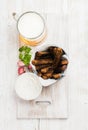 Beer snack set. Pint of pilsener in mug and rye bread croutons with garlic cream cheese sauce served fresh herb over Royalty Free Stock Photo