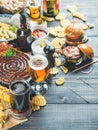 Beer and snack variety on dark wooden scorched background Royalty Free Stock Photo