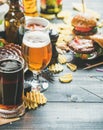 Beer and snack variety on dark wooden scorched background Royalty Free Stock Photo