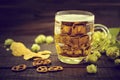 Beer and snacks on black wooden table. Draft cold beer in glass Royalty Free Stock Photo