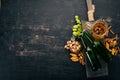 Beer and snacks. Salted crackers, Dried Fish, Chips, Nuts, Peanuts, Pistachios. On a black wooden background.