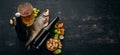 Beer and snacks. Salted crackers, Dried Fish, Chips, Nuts, Peanuts, Pistachios. On a black wooden background.