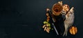 Beer and snacks. Salted crackers, Dried Fish, Chips, Nuts, Peanuts, Pistachios. On a black wooden background.