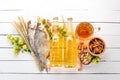 Beer and snacks. Salted crackers, Dried Fish, Chips, Nuts, Peanuts, Pistachios. On a white wooden background. Royalty Free Stock Photo