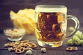 Beer and snacks set: chips, pistachio, pretzel, and nuts on bla Royalty Free Stock Photo