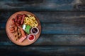 Beer snacks set. Grilled sausages and french fries served with tomato and BBQ sauce. Royalty Free Stock Photo