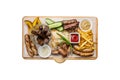 Beer snacks set. Grilled sausages and french fries with tomato and BBQ sauce, served on cutting board. Royalty Free Stock Photo