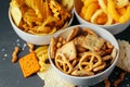 Beer snacks on stone table. Various crackers, potato chips. Top view