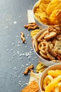 Beer snacks on stone table. Various crackers, potato chips. Top view