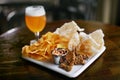 Beer With Snacks On Table In Pub Bar