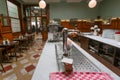 Beer tap on bar counter of old artistic cafe with antique furniture and interior in old-fashion style