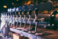 Beer tap row. Beer tap in the bar. Royalty Free Stock Photo