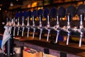 Beer tap row in bar counter Royalty Free Stock Photo