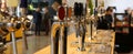 Beer taps lined up on the counter of a pub Royalty Free Stock Photo