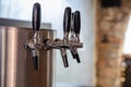 Beer taps in a row closeup, brew draft beer. Pub and brewery equipment Royalty Free Stock Photo