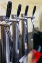 Beer taps in a row in the pub, selective focus Royalty Free Stock Photo