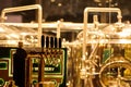 Beer taps to dispense beer in mug with selective focus and distillery in background of a brewery Royalty Free Stock Photo